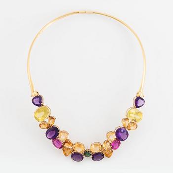 An 18K gold necklace set with faceted quartz and tourmaline.