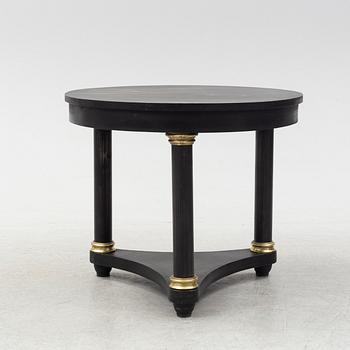 A contemporary empire style sheet metal center table.