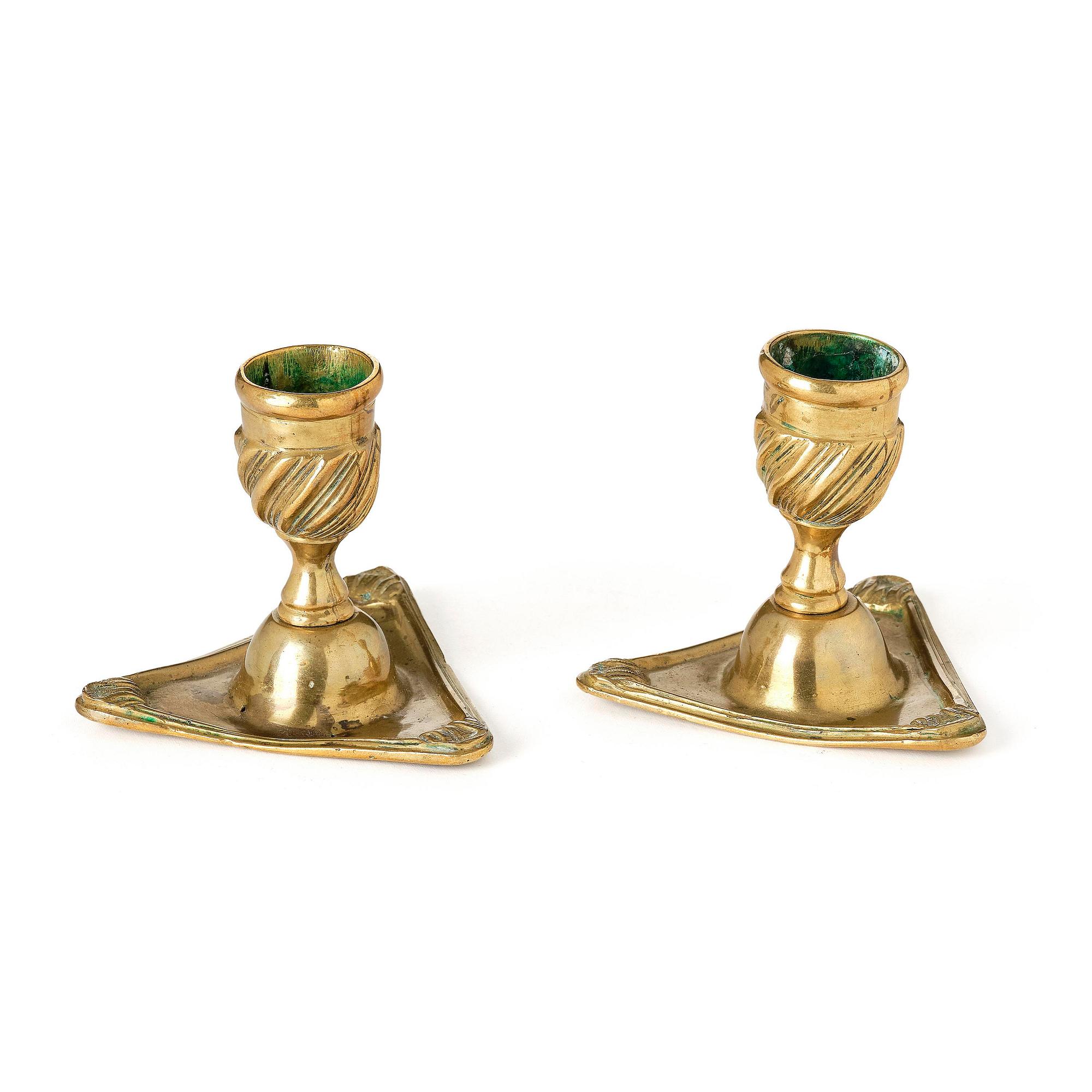 A pair of rococo brass candlesticks by Petter Hemming (master in Stockholm 1771-1807), 1772.