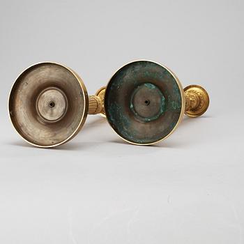 A pair of French Empire early 19th century candlesticks.