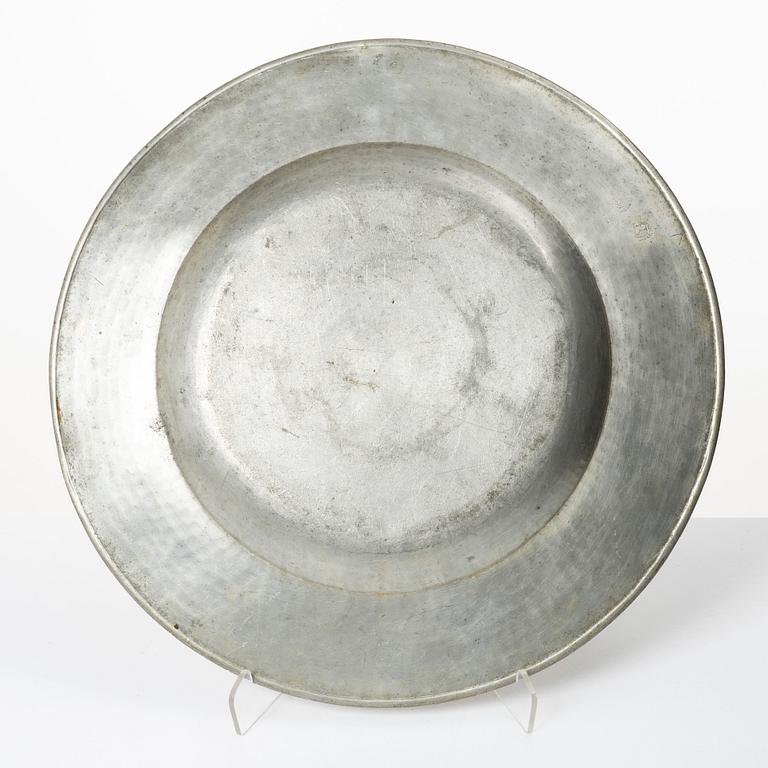 An English baroque pewter charger, dated 1672.