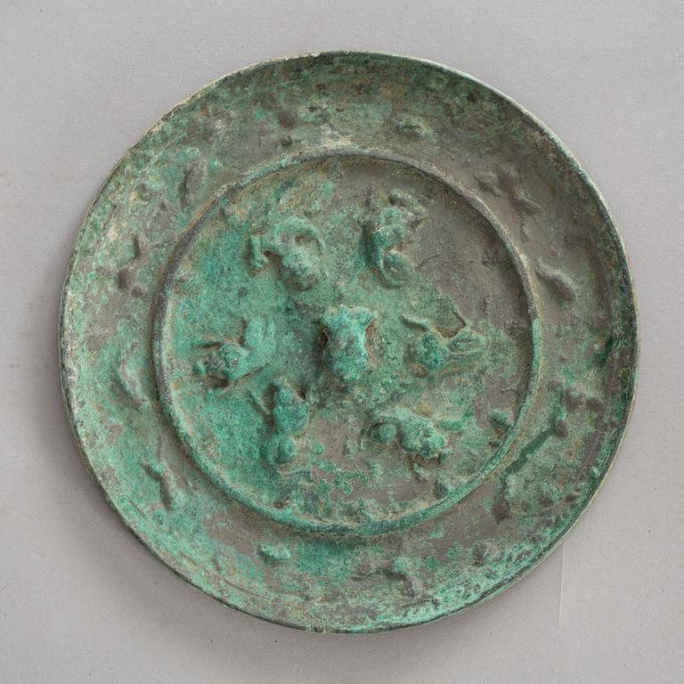 A broze mirror, presumably Tang dynasty (618-907 A.D.).