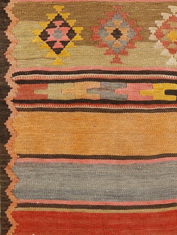 A semi-antique Nomadic Kilim rug, approx. 383 x 153 cm.