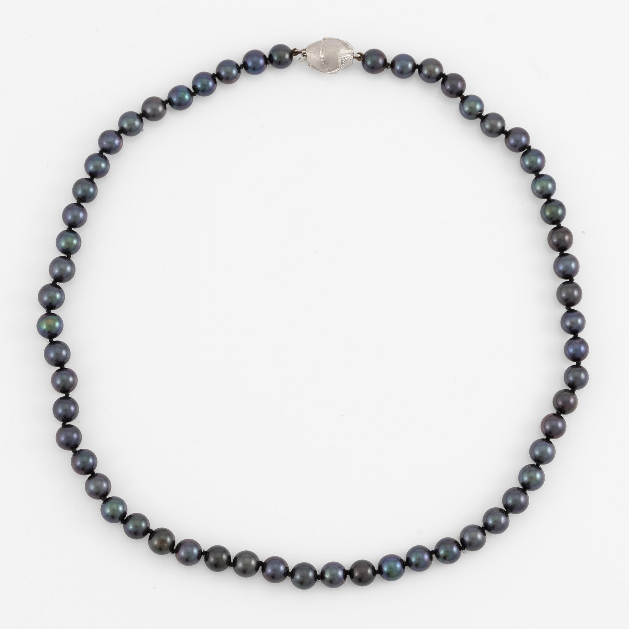 Necklace of cultured freshwater pearls, clasped with 14K white gold and round brilliant-cut diamonds.