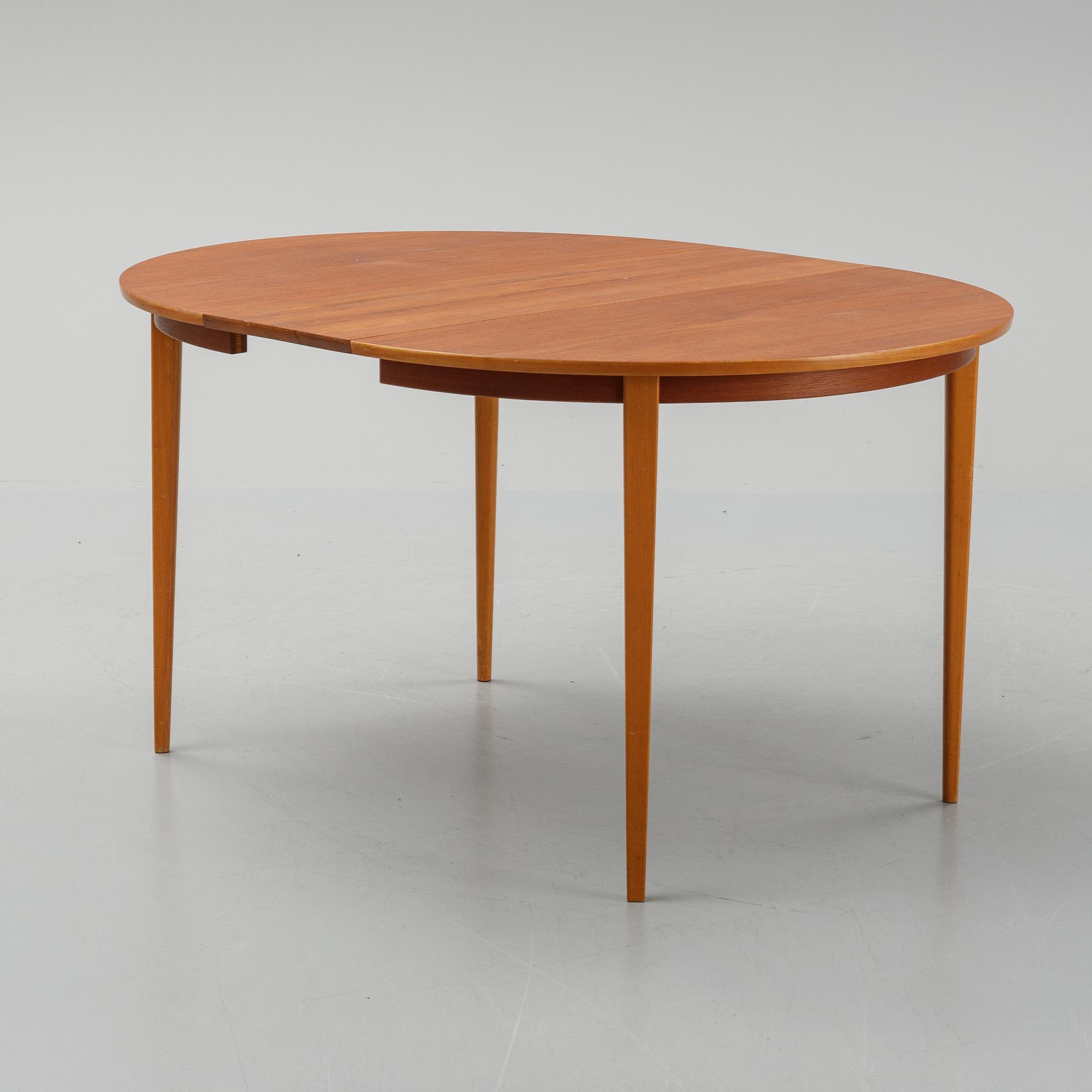 A teak dining table with 4 'Monaco' chairs, mid 20th century.