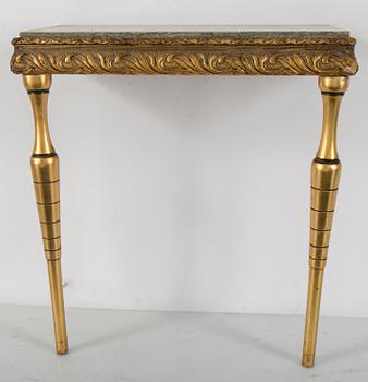 a bronzed mirror and a console table from the second half of the 20th century.