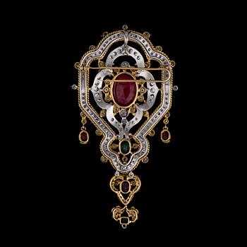 A BROOCH / PENDANT, 18K white and yellow gold, rubies, emeralds, diamonds. Iran. Weight c. 42,6 g.