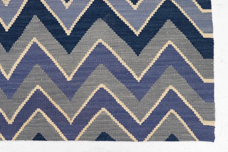 A flat-woven rug, c. 240 x 170 cm.