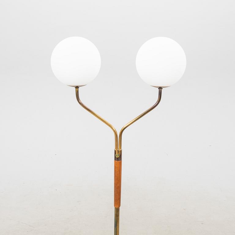 A mid 20th century teak and brass floor lamp.