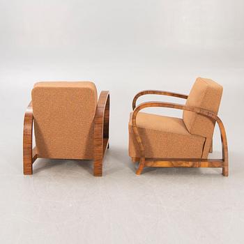 A pair of Art Deco walnut armchairs.