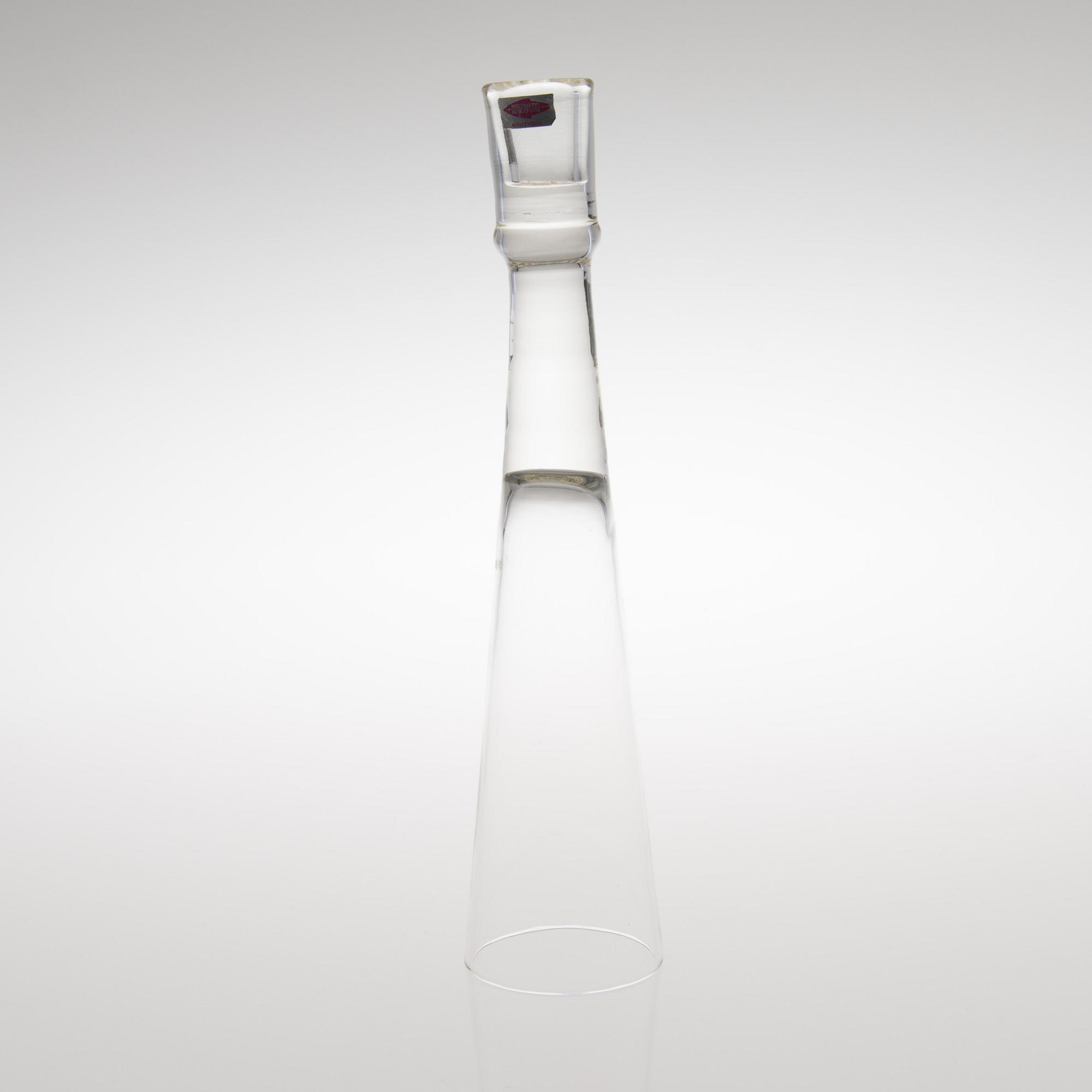 A GLASS CANDLESTICK, label marked Nuutajärvi Notsjö Boutique.
