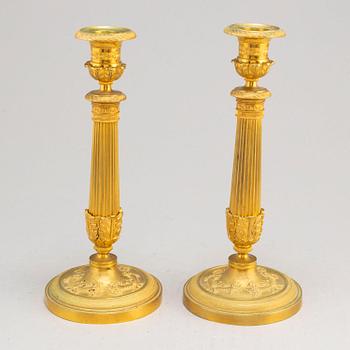 A pair of first half of the 19th century Empire candel sticks, gilded bronze, first half of the 19th century.
