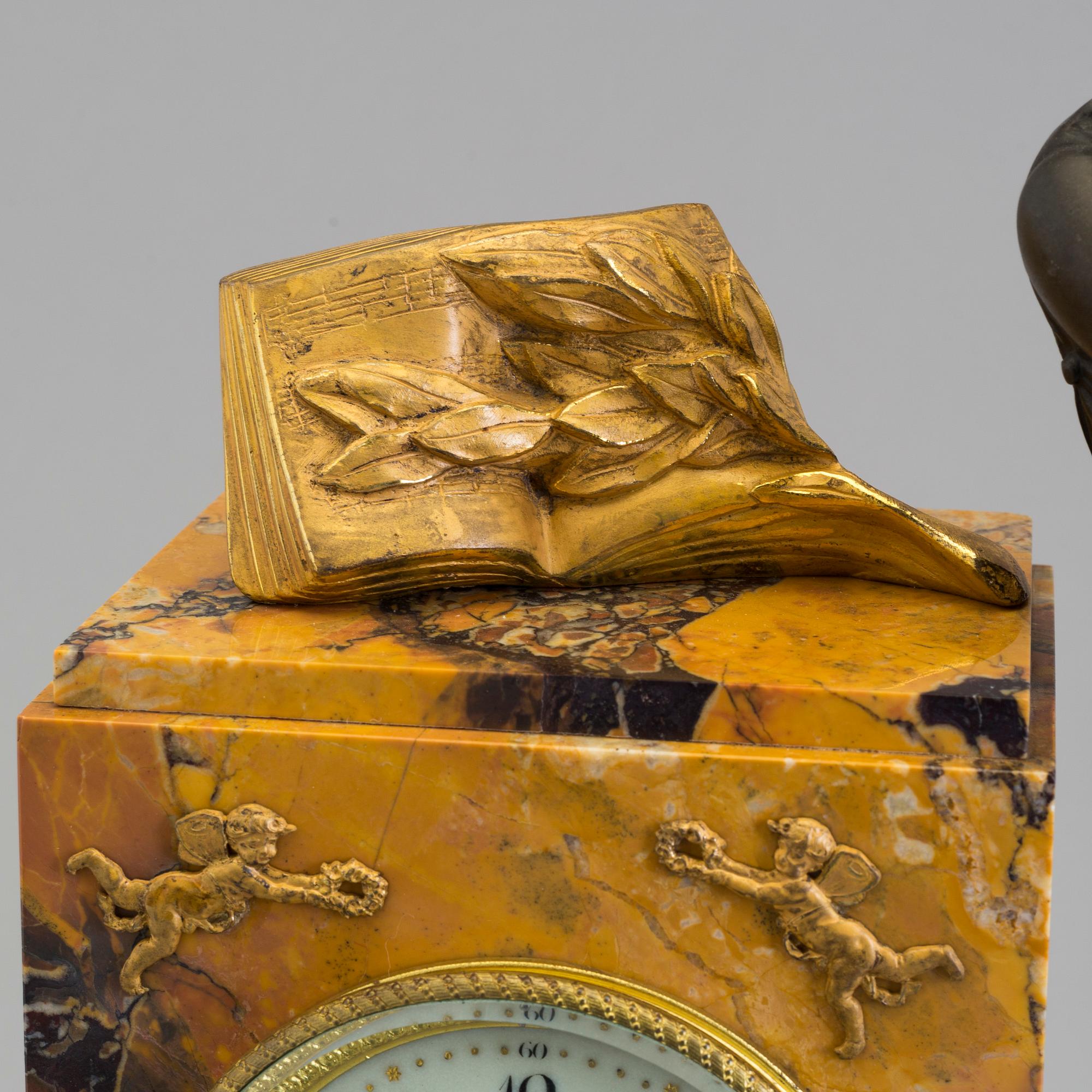 A turn of the century 1900 gilt brass and marble century mantle clock.