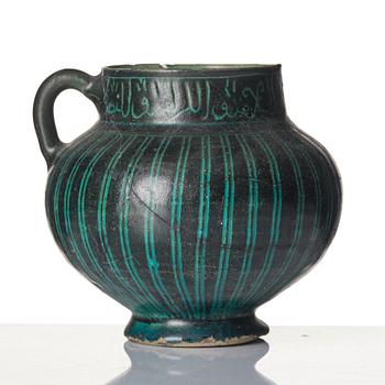 A Kashan Silhouette ware turquoise glazed pottery jug, central Iran, circa 1200.