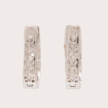 A pair of 18K white gold earrings set with round brilliant-cut diamonds.