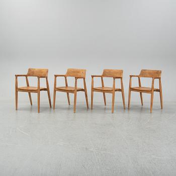 Four contemporary teak armchairs.