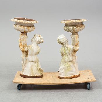 An end of the 20th Century pair of cast iron flower pots.