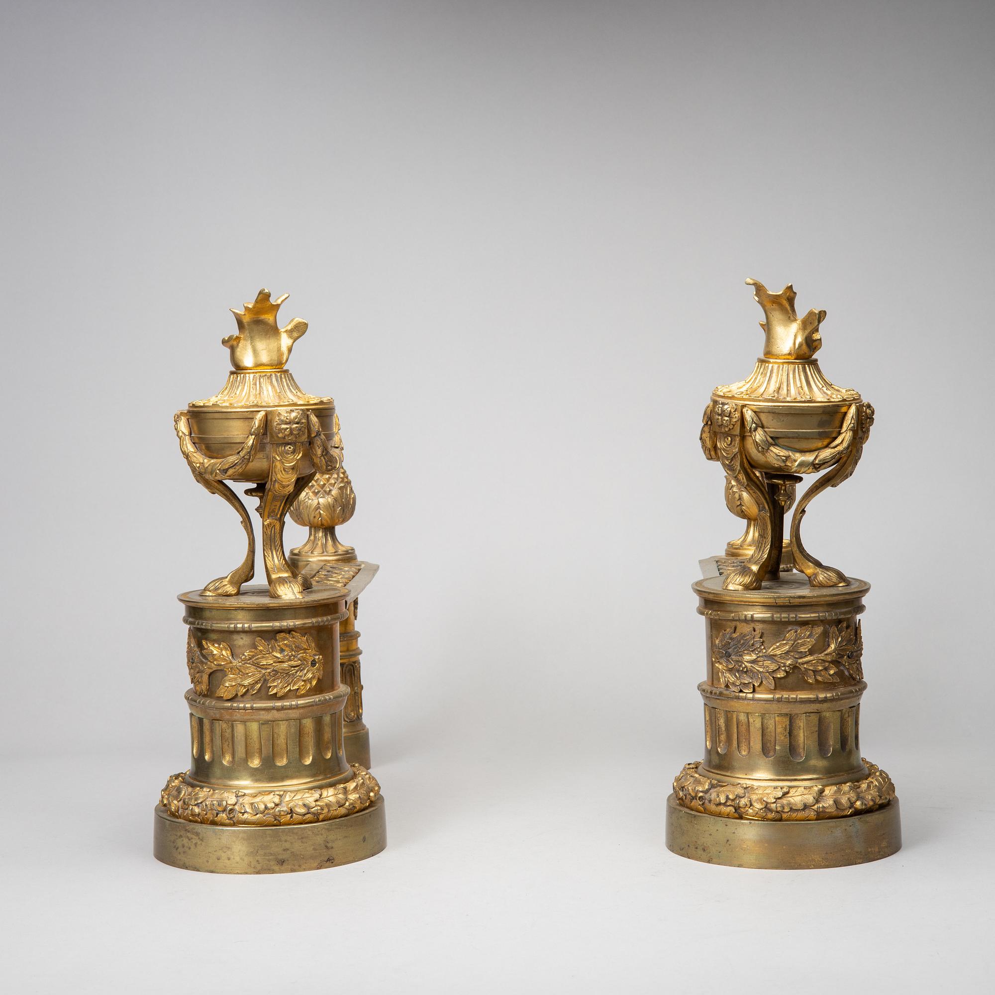 A pair of gilt brass Louis-XVI style andirons, second half of the 19th Century.