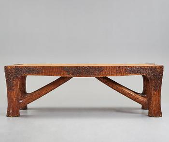 Gustaf Fjaestad, an Art Nouveau carved pine table, Arvika Sweden 1914, a double to the table in the Thiel Collection,