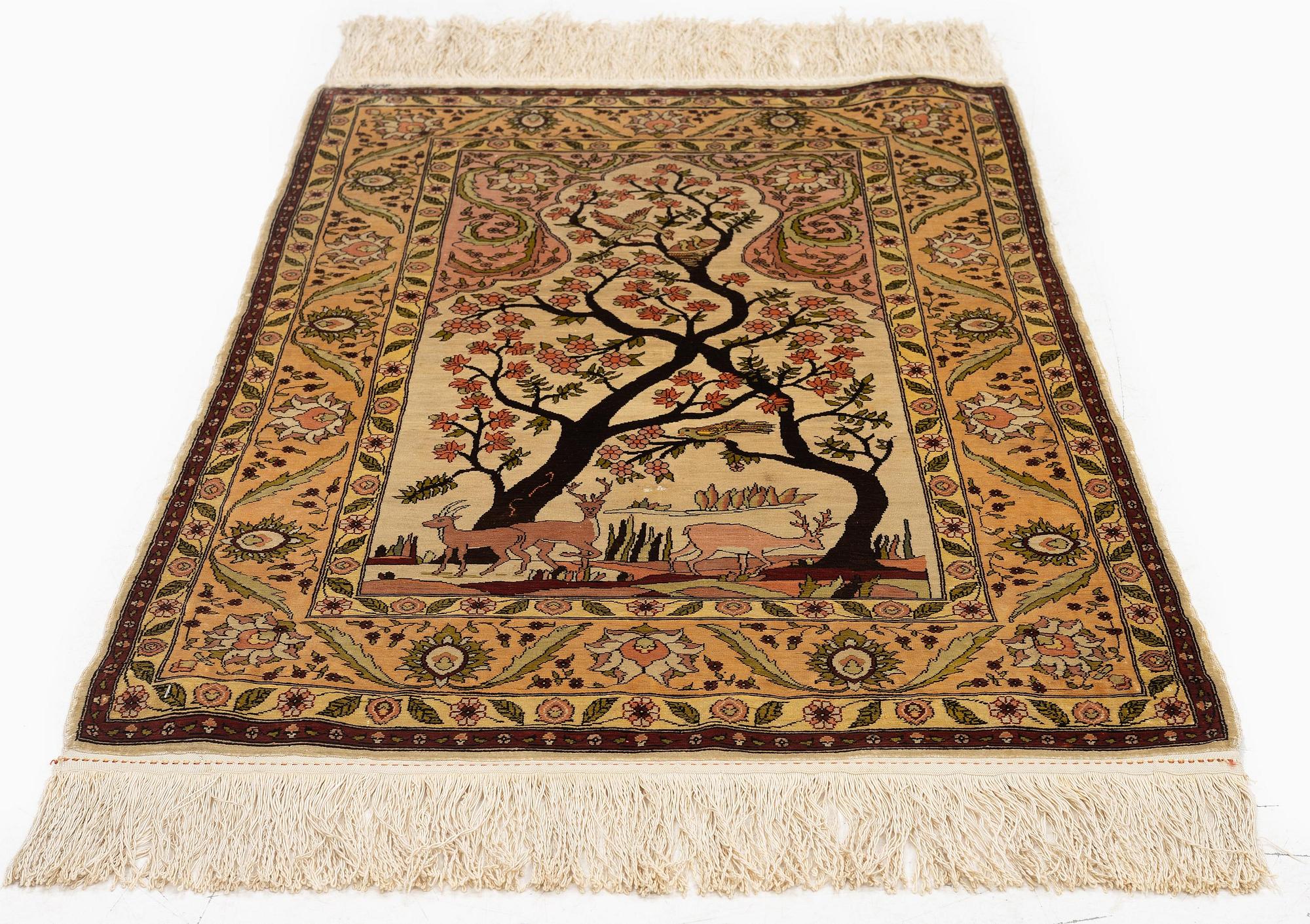 A semi-antique / old silk Hereke rug, West Anatolia, c. 100 x 60 cm.
