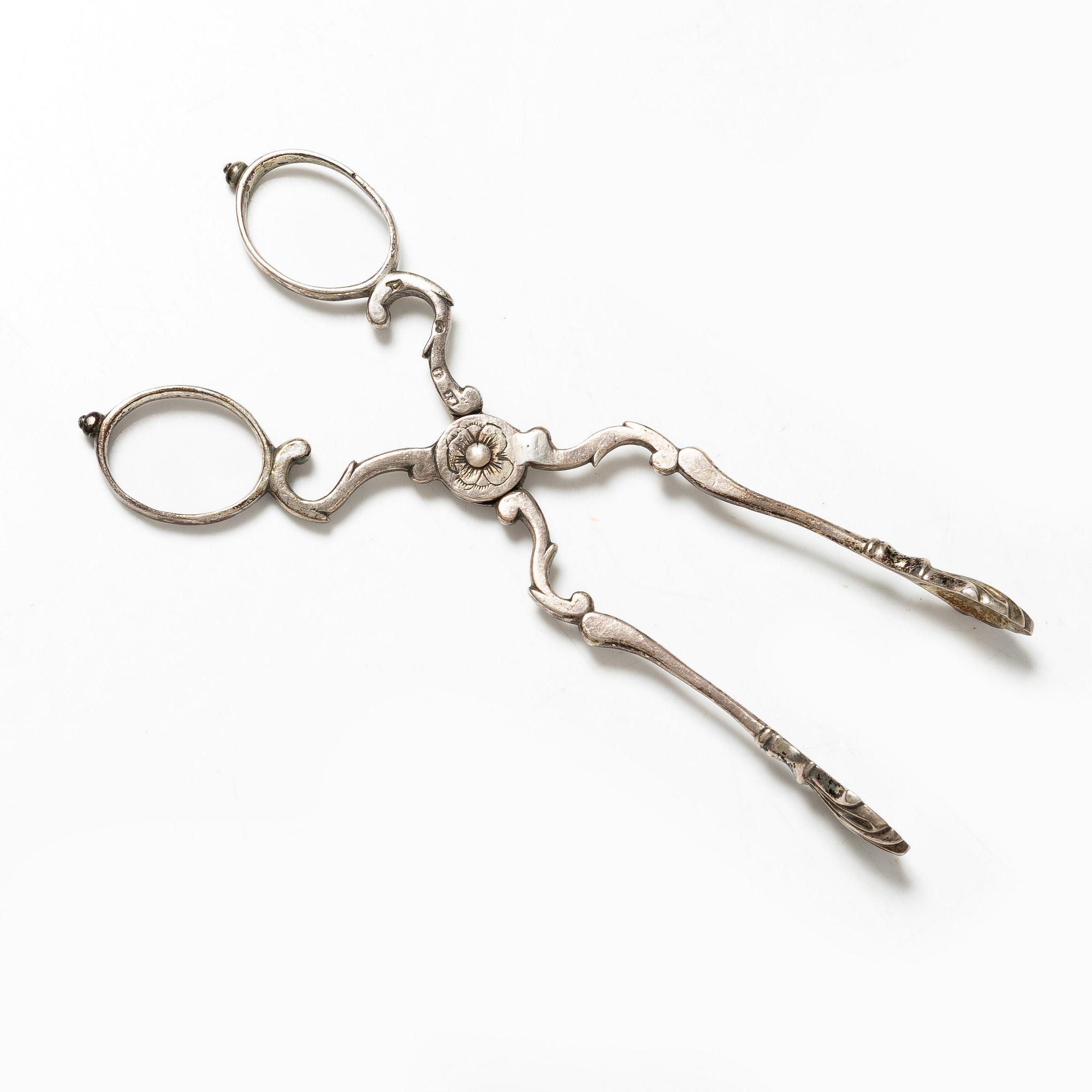 A pair of Swedish silver sugar tongs, mark of Isak Sauter, Stockholm, 1759. Rococo.