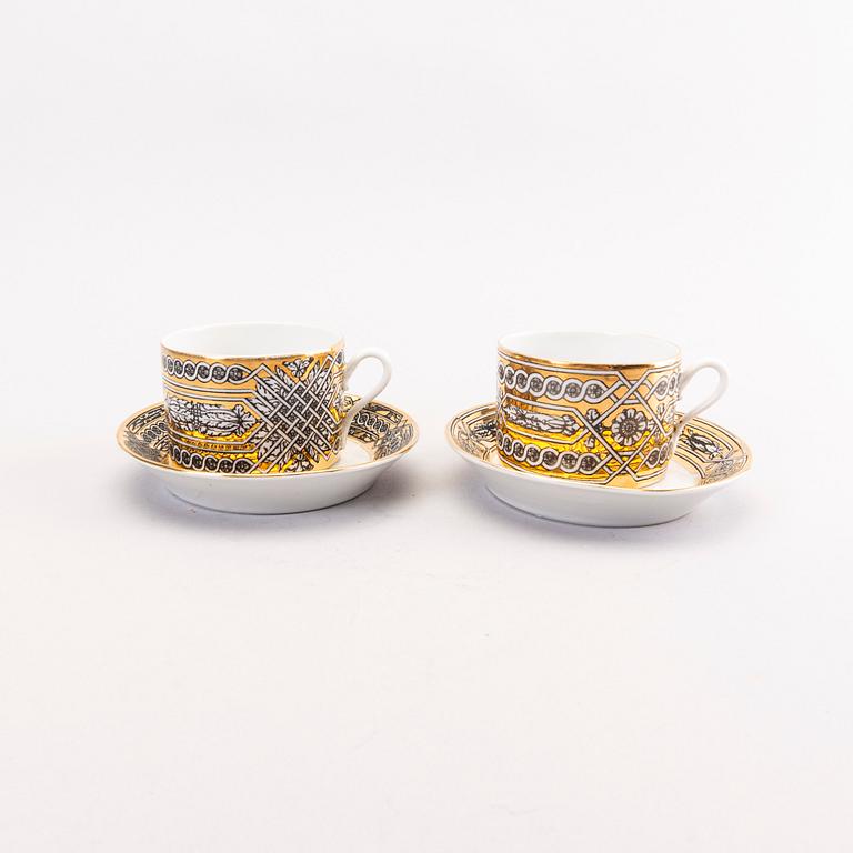 Piero Fornasetti a set of four coffee cups with saucers and two ashtrays.