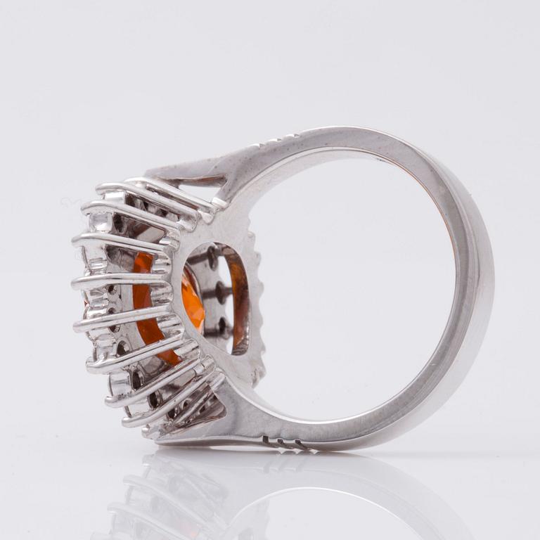 A circa 7.50 ct fancy orange sapphire and brilliant-cut diamond ring.