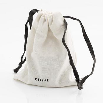Céline, armring, guldfärgad metall och skinn.
