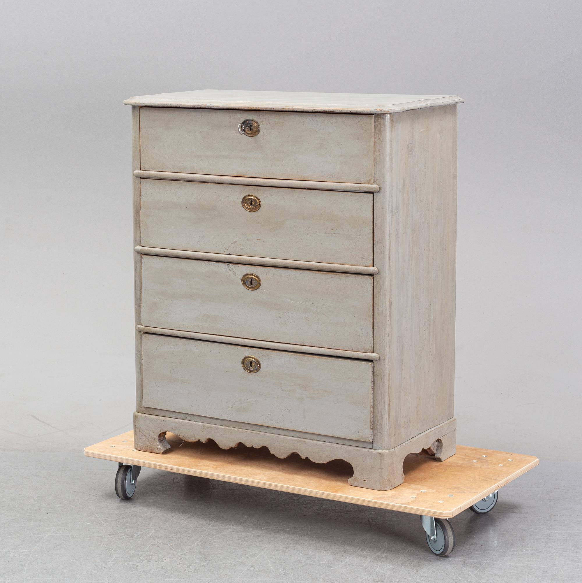 A painted chest of drawers from around the year 1900.