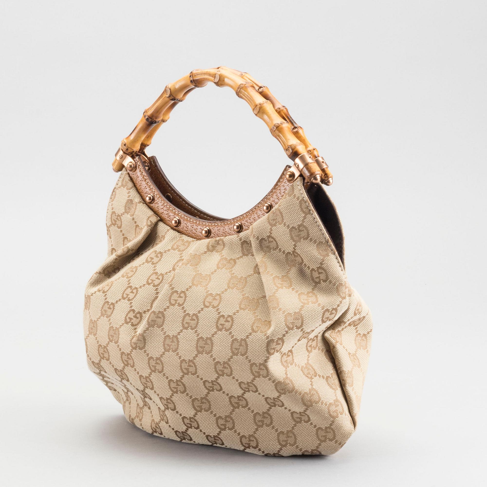 A GUCCI BAG, "STUDDED  BAMBOO HANDLE".