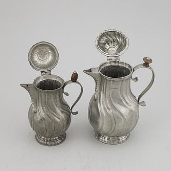 A pair of rococo style pewter coffee pots, from around year 1900.