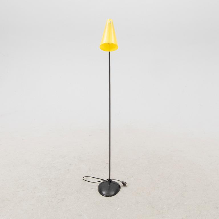 A 1050s metal and plastic floor lamp.