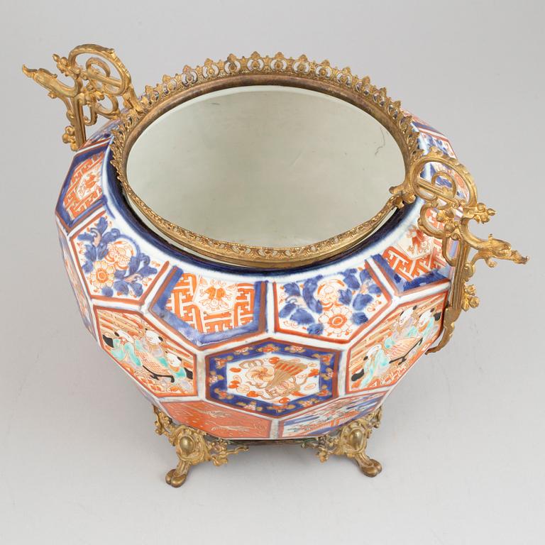 A Japanese plant pot with brass mounts, late 19th century.