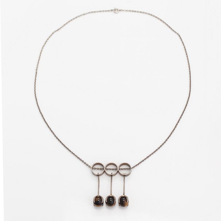 Elis Kauppi, A silver necklace with tiger's eye pearls. Kupittaan kulta, Turku 1965.