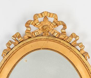 An oval Gustavian style mirror, early 20th Century.