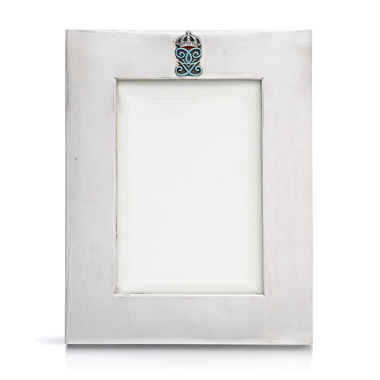 A silver and enamel frame with glass, mark of CG Hallberg, Stockholm 1935.