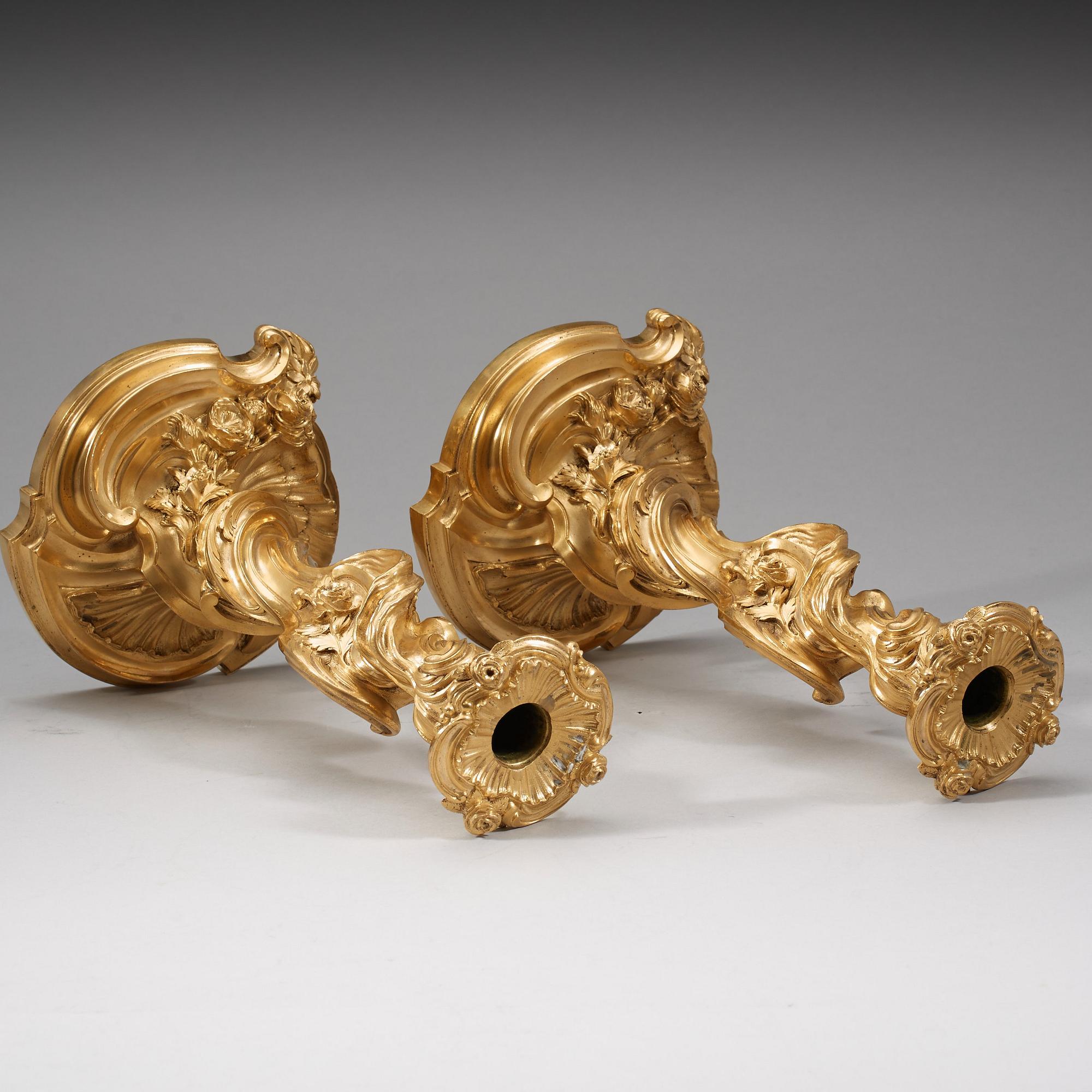 A pair of Louis XV 18th century gilt bronze candlesticks after the model by Juste-Aurèle Meissonnier.