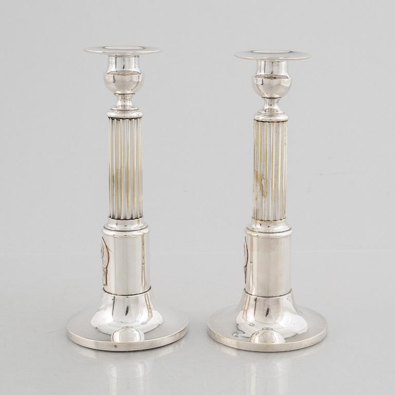 A pair of candlesticks and a commemorative pin from the Olympic Games in Stockholm 1912.