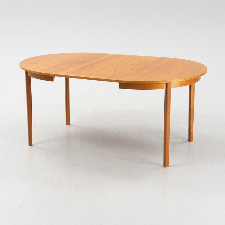 A teak veneer dining table from the mid 20th century.