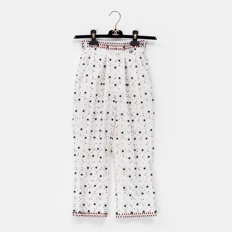 Chanel, a pair of broderie anglais trousers with pearls, size 34.