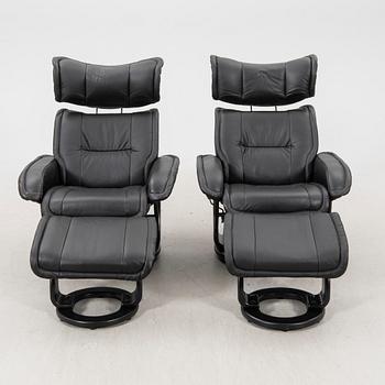 A pair of leather easy chairs and footstools from the 21st century.