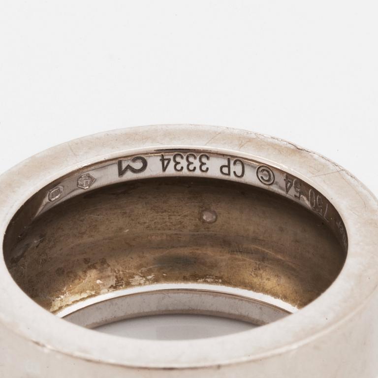 A Cartier 18K white gold ring set with a round brilliant-cut diamond.