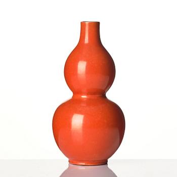 A coral red-enameled double-gourd vase, Qing dynasty with Jiaqing mark (1796-1820).