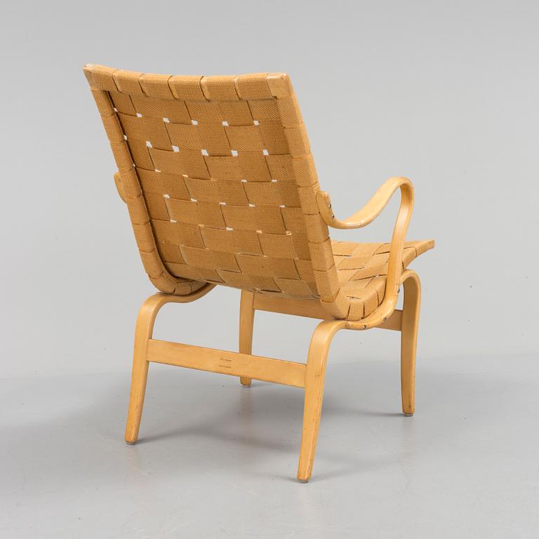 an "Eva" armchair by BRUNO MATHSSON 1963.