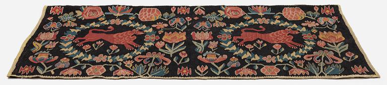 A cushion, 'Red Lion' (Rött Lejon), tapestry weave, c. 98 x 49 cm, Southwestern Scania, first part of the 19th century.