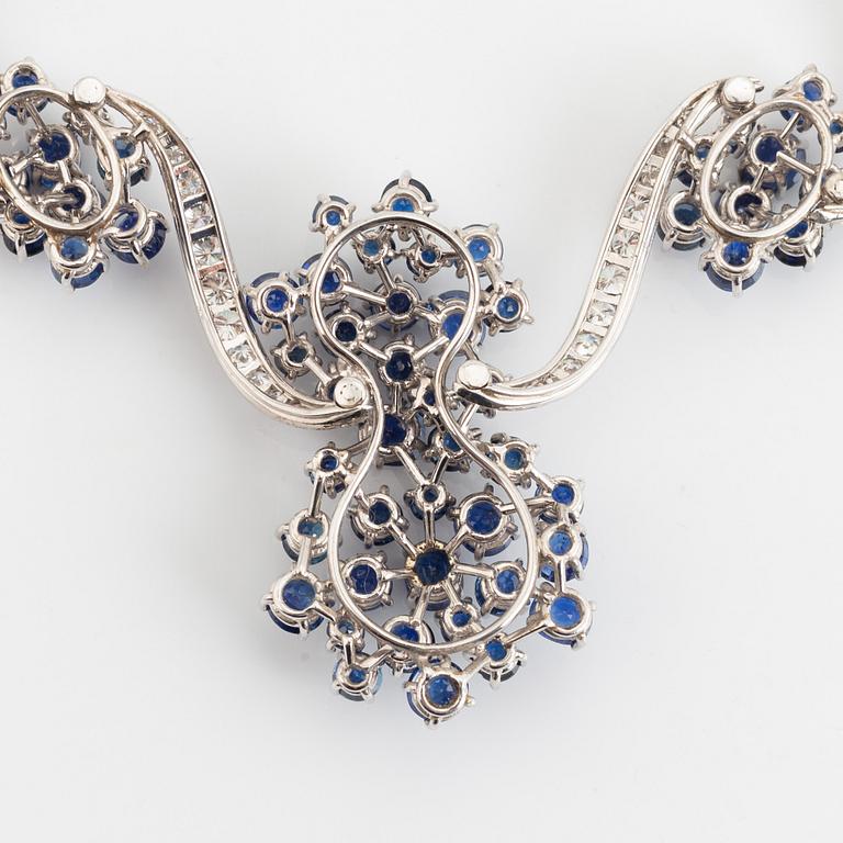 An 18K white gold necklace set with round brilliant-cut diamonds and sapphires.
