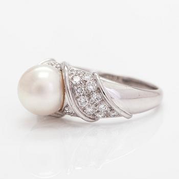 An 18K white gold ring, with a cultured pearl and diamonds totalling approximately 0.70 ct.