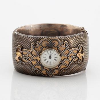 Silver bangle with watch.