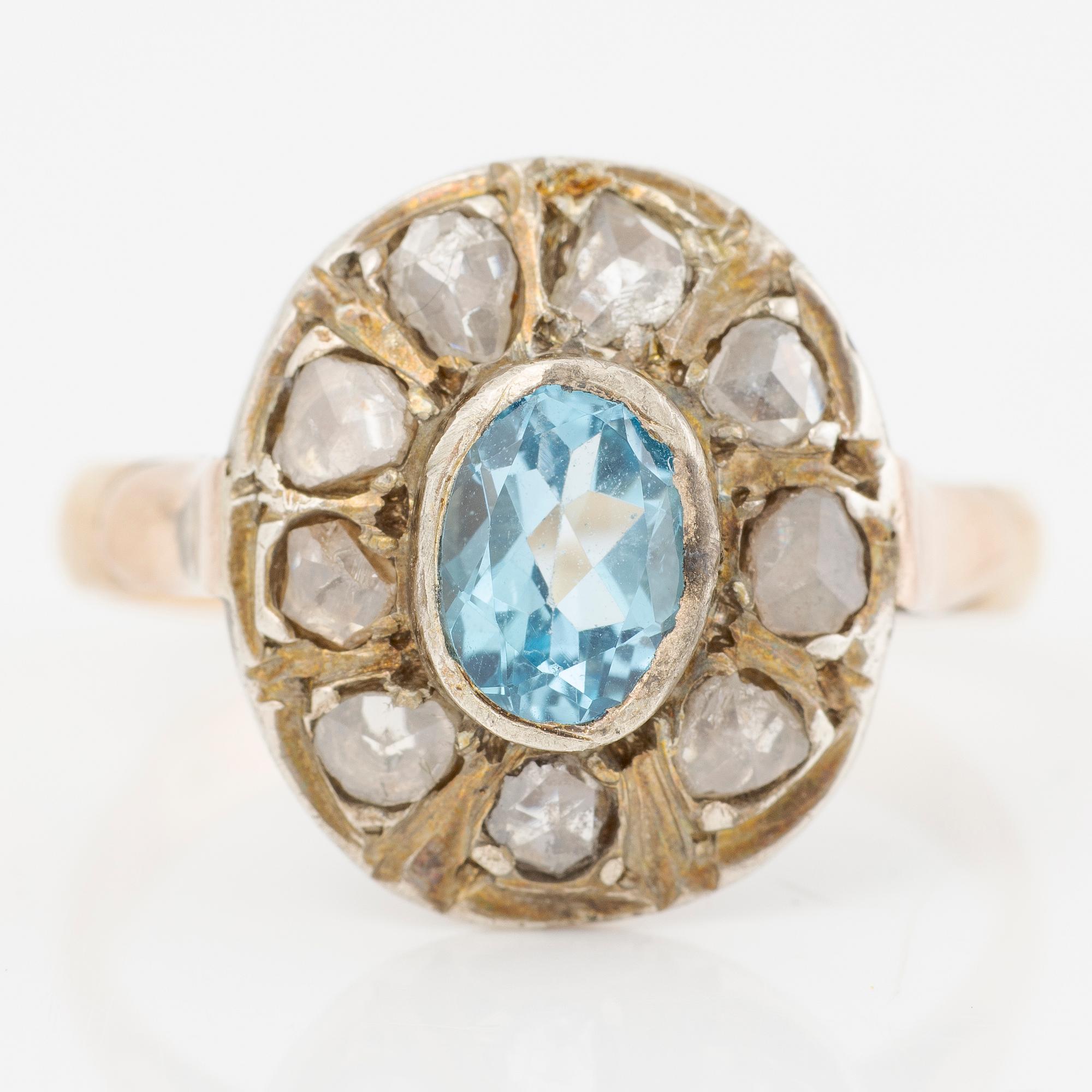 Ring in 14K gold with a faceted topaz and rose-cut diamonds.