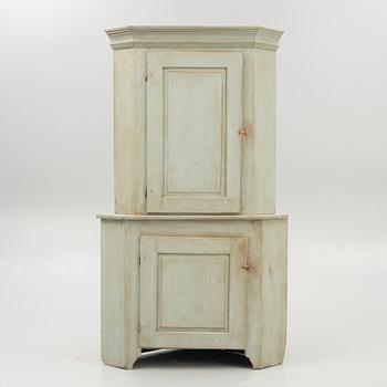 A 19th century corner cabinet.